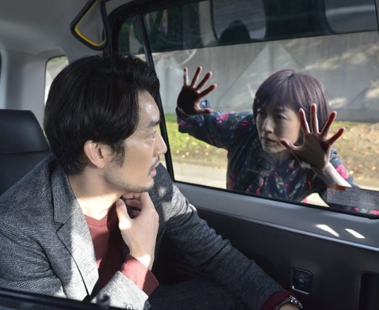 タクシーの窓に張り付くリカと怯える本間隆雄（画像は『【公式】リカ（オトナの土ドラ）　2019年11月18日付Instagram「第七話、リカさんが本間さんを追いかけます。」』のスクリーンショット）