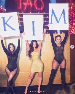 「キム」と書かれた文字を掲げる3姉妹（画像は『Kim Kardashian West　2020年10月23日付Instagram「All I can say is WOW!」』のスクリーンショット）