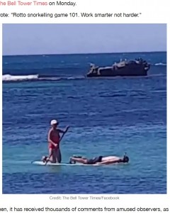 一生懸命に漕ぐ女性に対して、うつ伏せで海中の景色を楽しむ男性（画像は『LADbible　2020年12月22日付「Footage Shows Man Getting Paddled About Face-Down While Snorkelling In Australia」（Credit: The Bell Tower Times/Facebook）』のスクリーンショット）