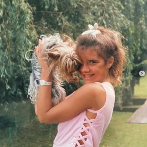 犬の“バンビ”と寄り添う13歳当時のヴィクトリア（画像は『Victoria Beckham　2021年8月26日付Instagram「Some retro moments for ＃InternationalDogDay!」』のスクリーンショット）