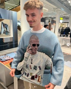 父デヴィッド・ベッカムの姿をあしらったセーターを着るロメオ。2001年に撮影した「アディダス」のキャンペーン写真がモチーフだ（『ROMEO　Instagram「＠davidbeckham ＠victoriabeckham」』より）